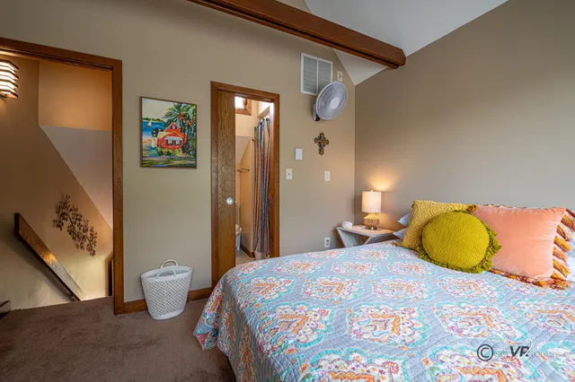 a bedroom with a large bed and a couch