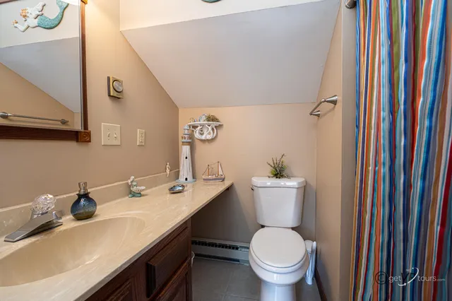 a bathroom with a sink toilet and a mirror