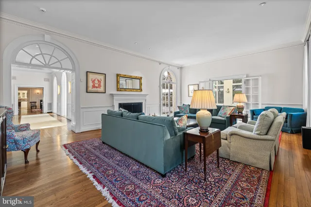 a view of a dining room with furniture a chandelier and wooden floor