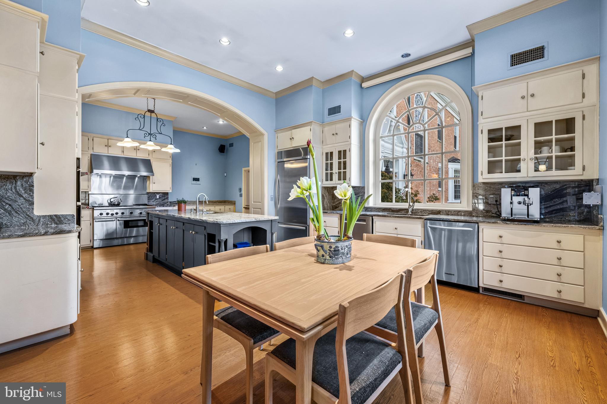 20 Blythewood Road Baltimore, MD 21210 - Photo 29 of 95 a kitchen with stainless steel appliances kitchen island granite countertop a table chairs and wooden floor