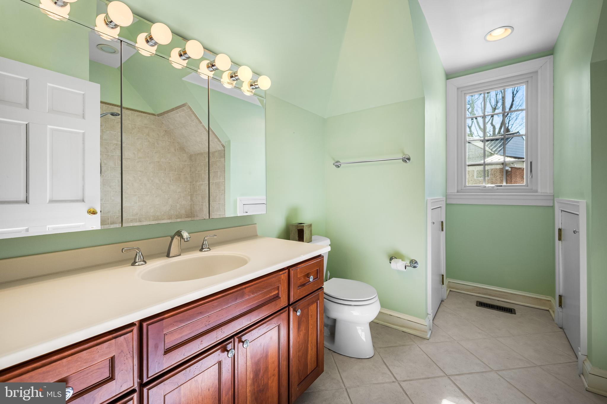 20 Blythewood Road Baltimore, MD 21210 - Photo 73 of 95 a spacious bathroom with a double vanity sink toilet and a mirror