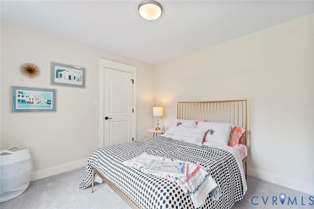 3076 Braehead Road Powhatan, VA 23139 - Photo 30 of 41 a bedroom with a bed and a lamp