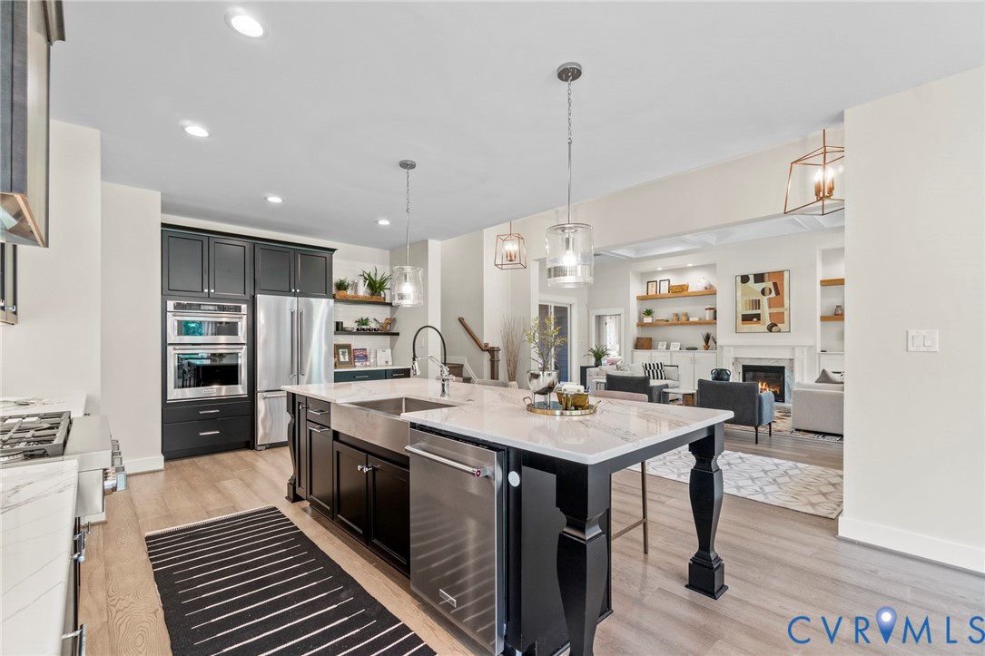 3076 Braehead Road Powhatan, VA 23139 - Photo 10 of 41 a large kitchen with sink a refrigerator and chairs
