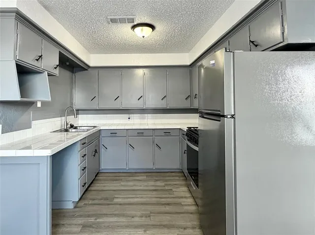 a kitchen with a sink stove and refrigerator