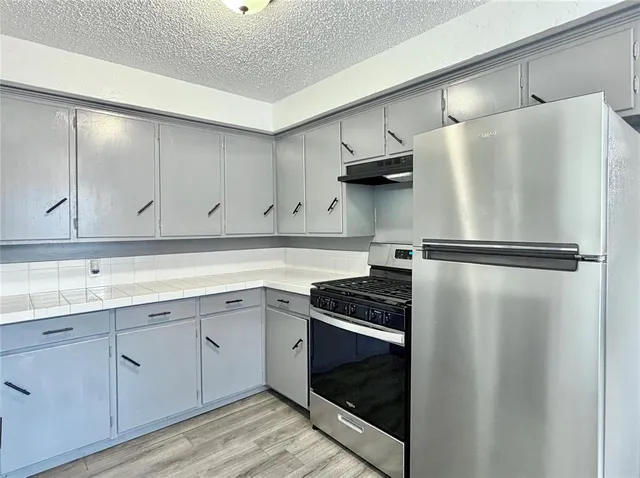 a kitchen with a sink and stainless steel appliances