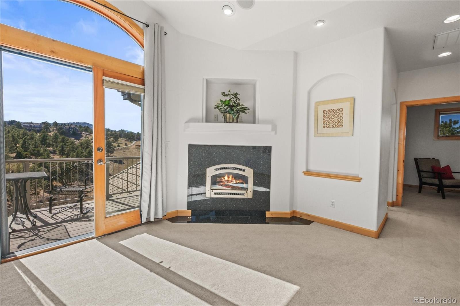 156 South Lookout Mountain Road Golden, CO 80401 - Photo 26 of 50 a living room with furniture and a fireplace