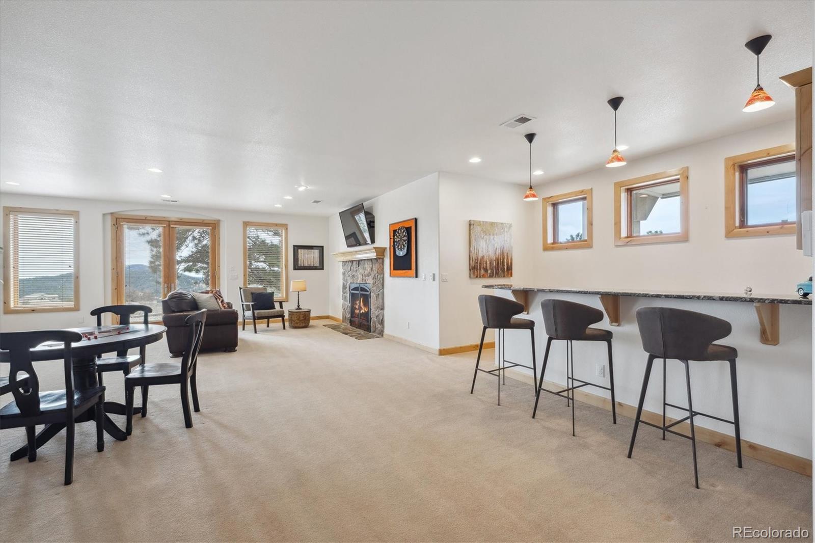 156 South Lookout Mountain Road Golden, CO 80401 - Photo 39 of 50 a living room with furniture and a dining table with chairs