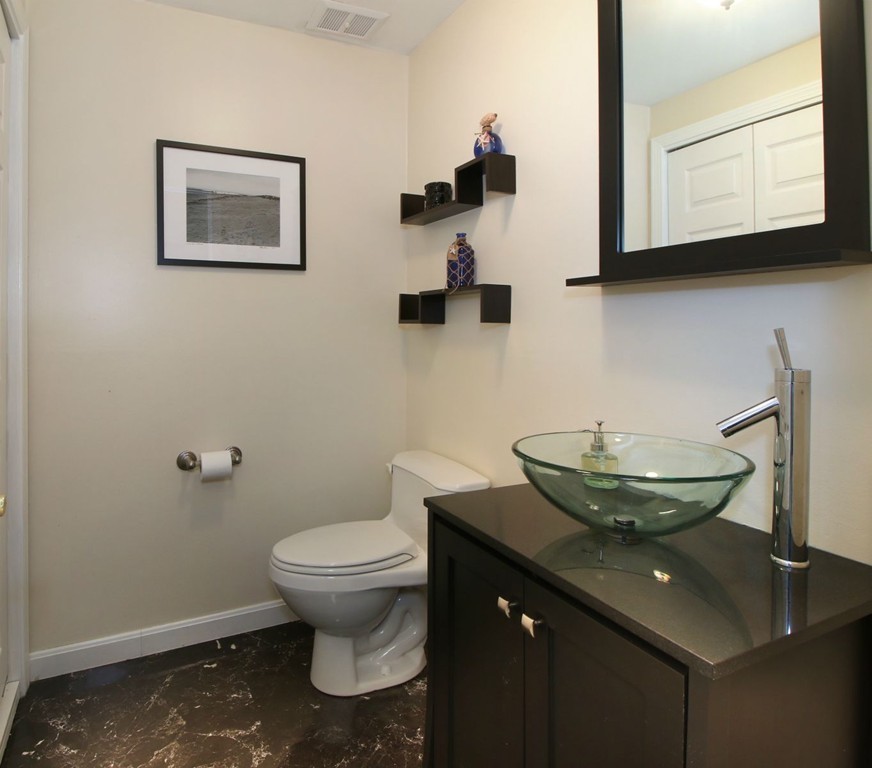 90 Roper Street, Unit D Lowell, MA 01852 - Photo 12 of 17 a bathroom with a granite countertop sink and a toilet
