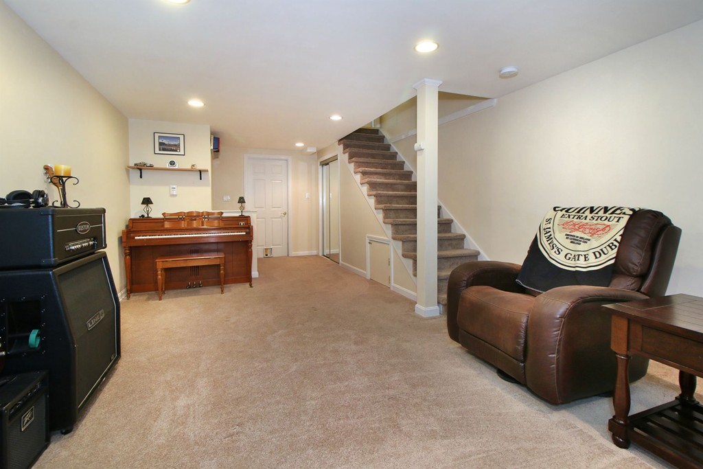 90 Roper Street, Unit D Lowell, MA 01852 - Photo 13 of 17 a living room with furniture and a piano