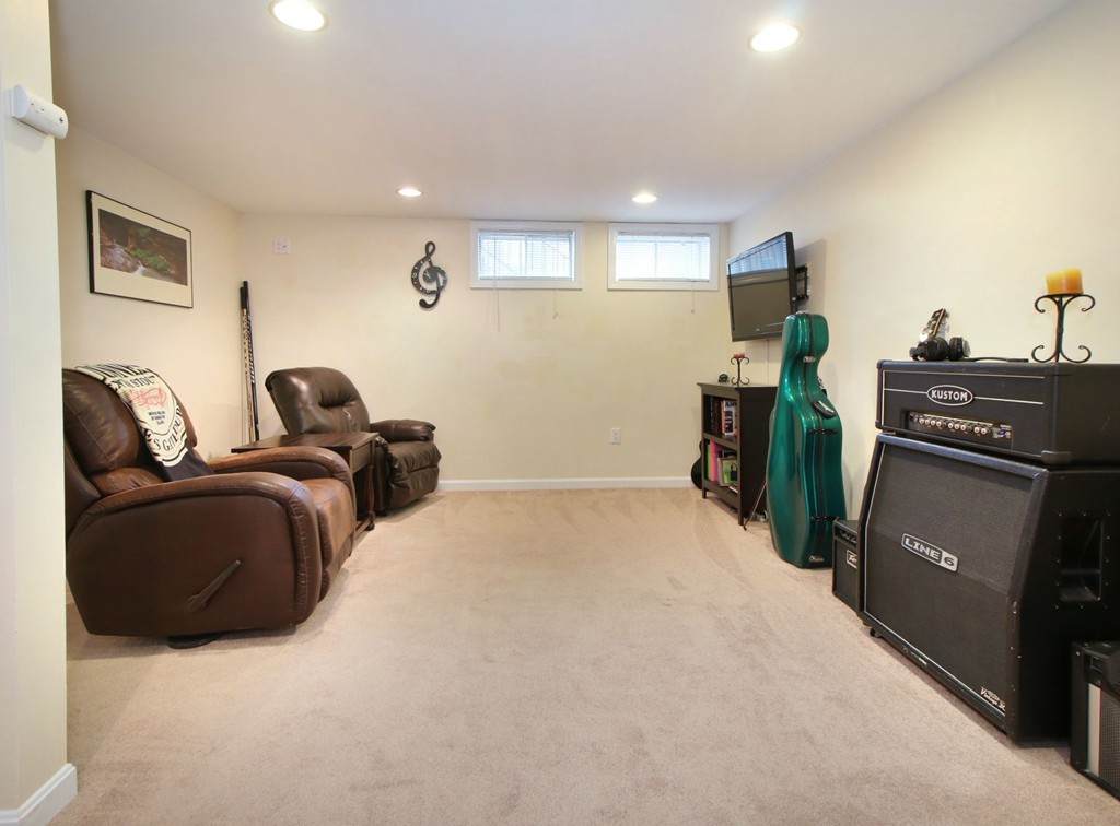 90 Roper Street, Unit D Lowell, MA 01852 - Photo 15 of 17 a bedroom with a bed and a television