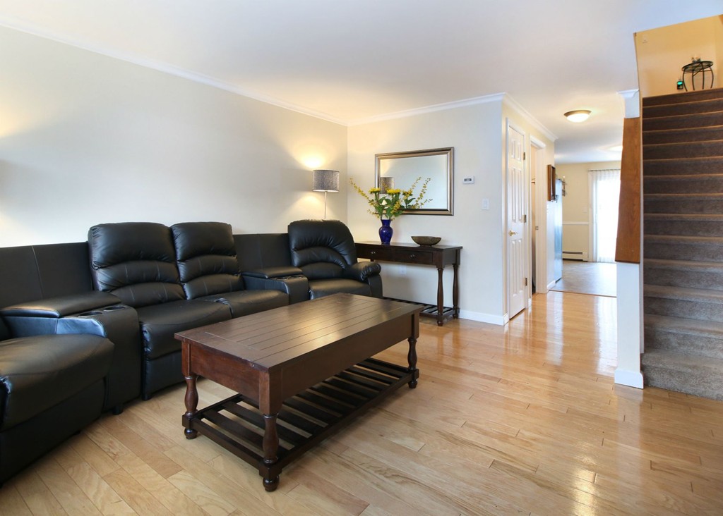 90 Roper Street, Unit D Lowell, MA 01852 - Photo 2 of 17 a living room with furniture and a table