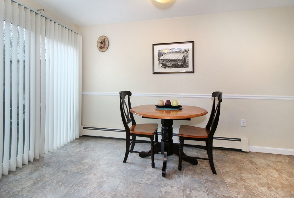 90 Roper Street, Unit D Lowell, MA 01852 - Photo 6 of 17 a view of a dining room with furniture and a window