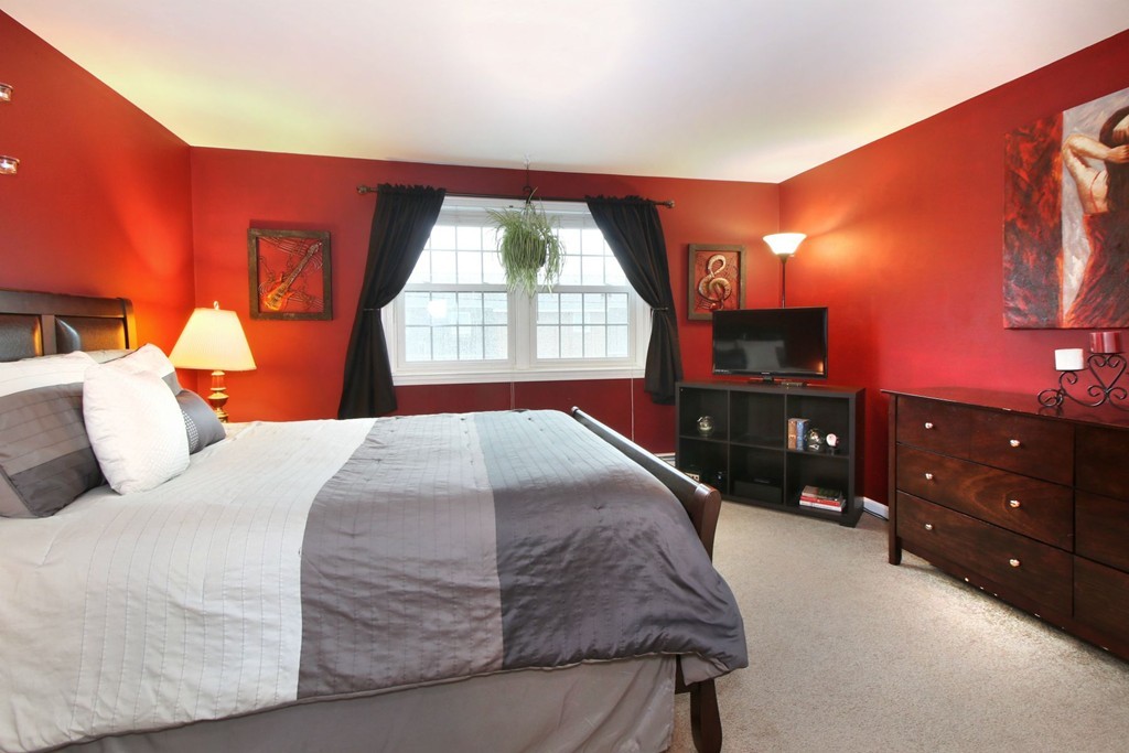 90 Roper Street, Unit D Lowell, MA 01852 - Photo 8 of 17 a bedroom with a bed and a flat screen tv