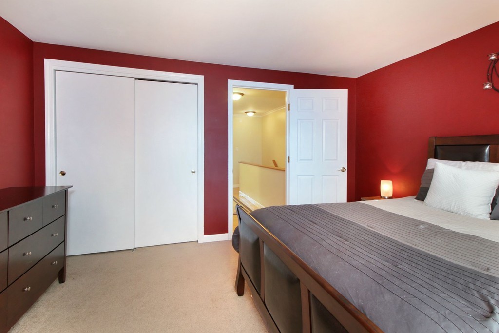 90 Roper Street, Unit D Lowell, MA 01852 - Photo 9 of 17 a bedroom with a bed and a dresser