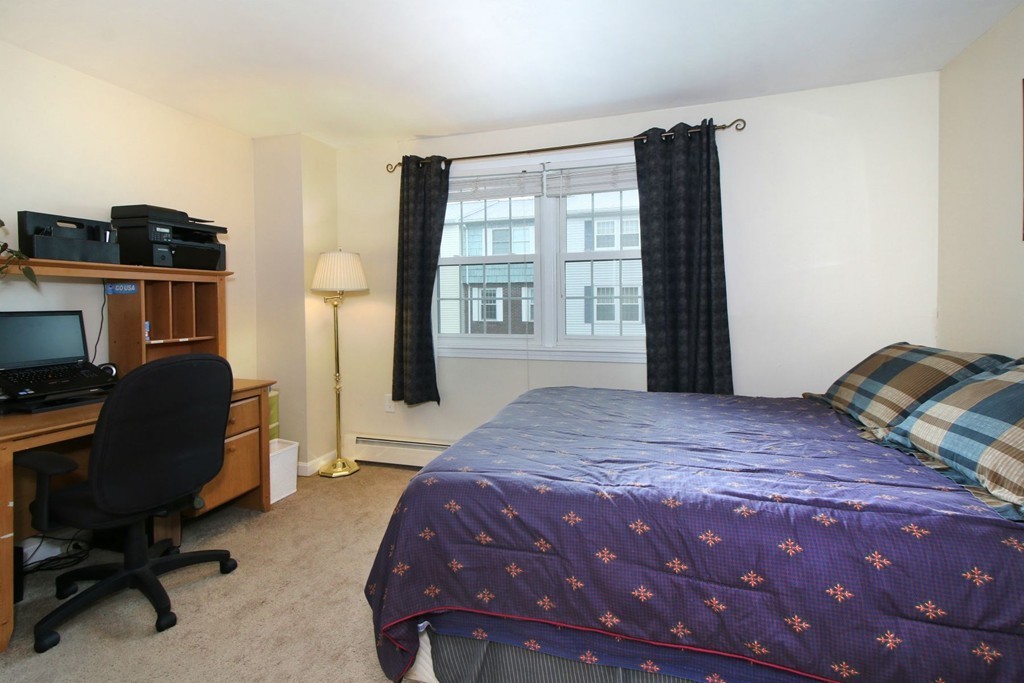 90 Roper Street, Unit D Lowell, MA 01852 - Photo 10 of 17 a bedroom with a bed furniture and a window