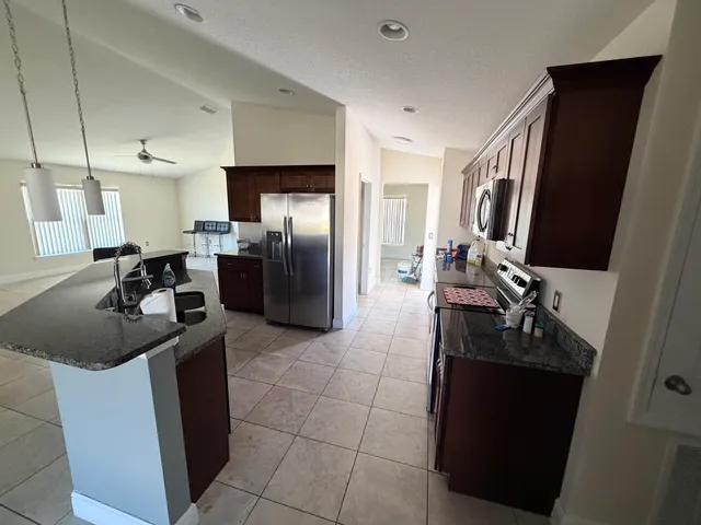 a kitchen with a sink stove and refrigerator