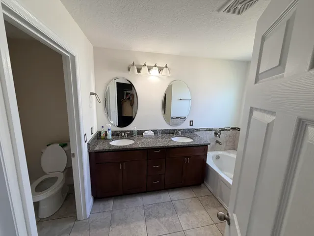 a bathroom with a double vanity sink and a mirror