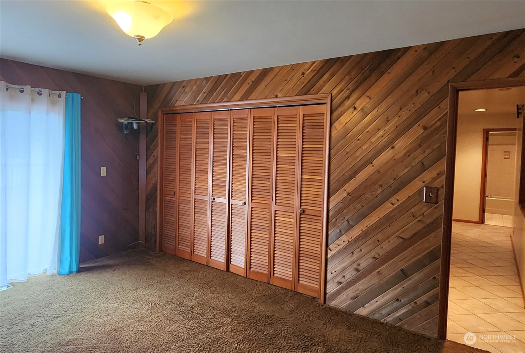 976 Ocean Beach Road Hoquiam, WA 98550 - Photo 11 of 34 a view of a room with wooden walls