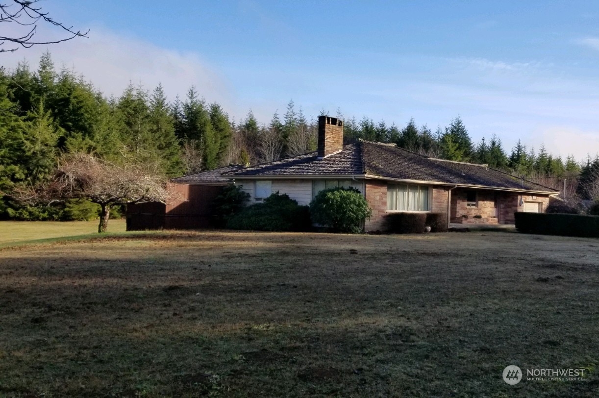 976 Ocean Beach Road Hoquiam, WA 98550 - Photo 2 of 34 a view of a house with a yard