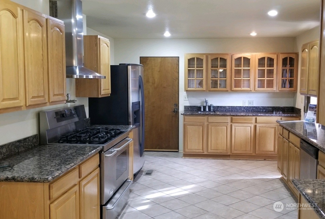 976 Ocean Beach Road Hoquiam, WA 98550 - Photo 3 of 34 a kitchen with stainless steel appliances granite countertop a stove a sink and a refrigerator
