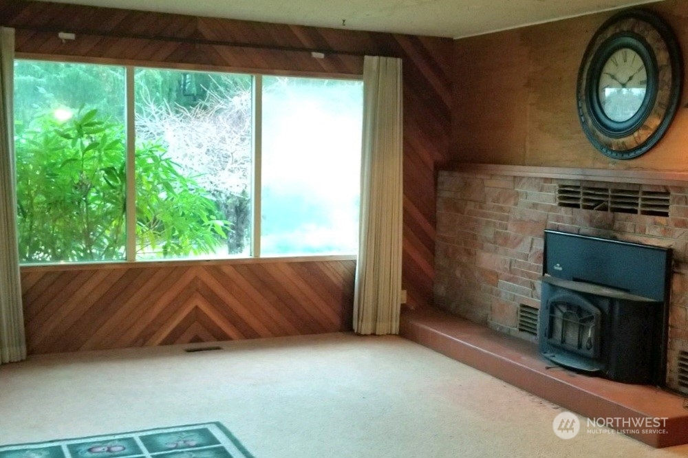 976 Ocean Beach Road Hoquiam, WA 98550 - Photo 9 of 34 view of a room with a fireplace and a window