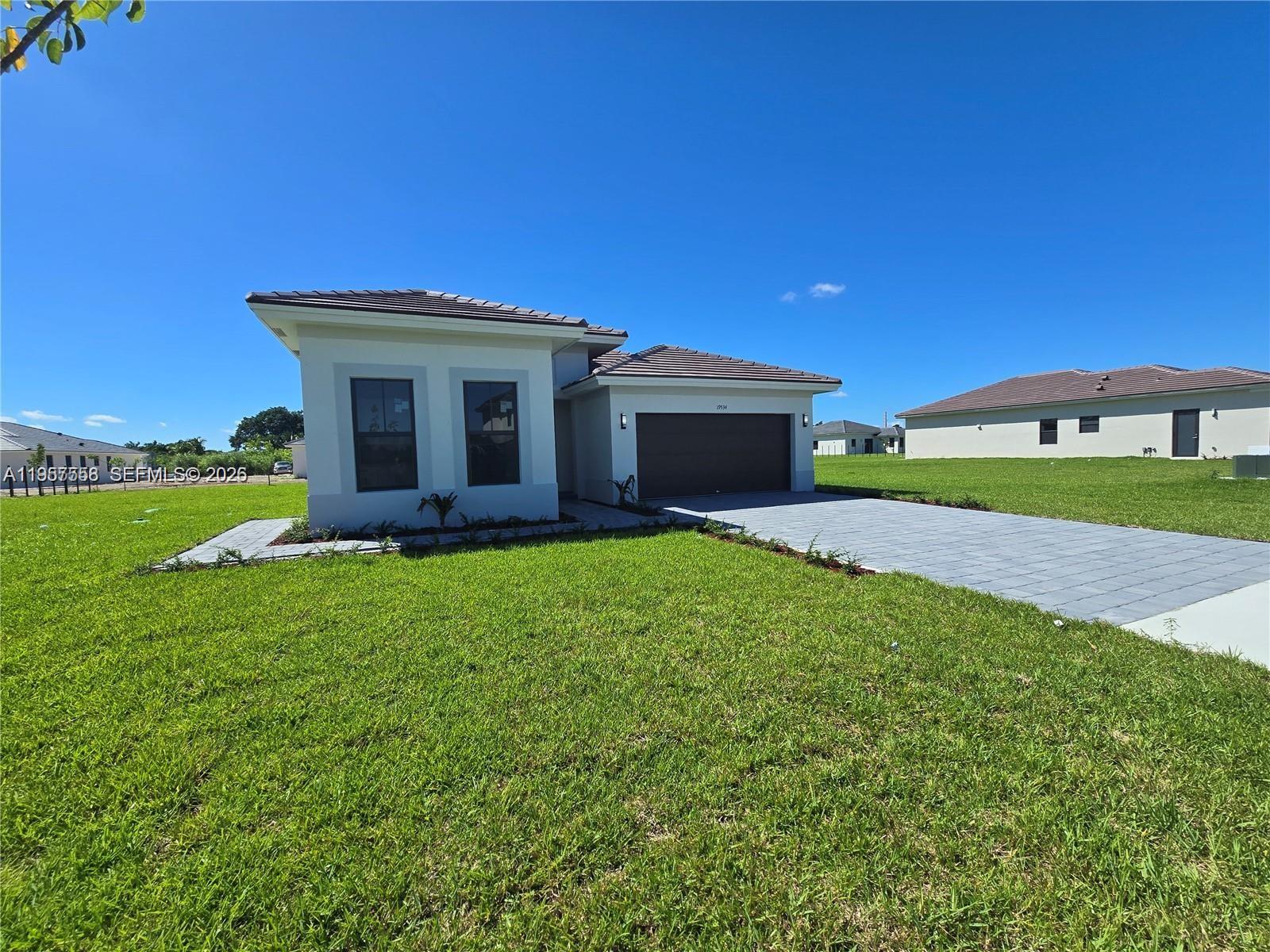 19534 Southwest 324th Street Homestead, FL 33030 - Photo 2 of 86 a front view of a house with garden