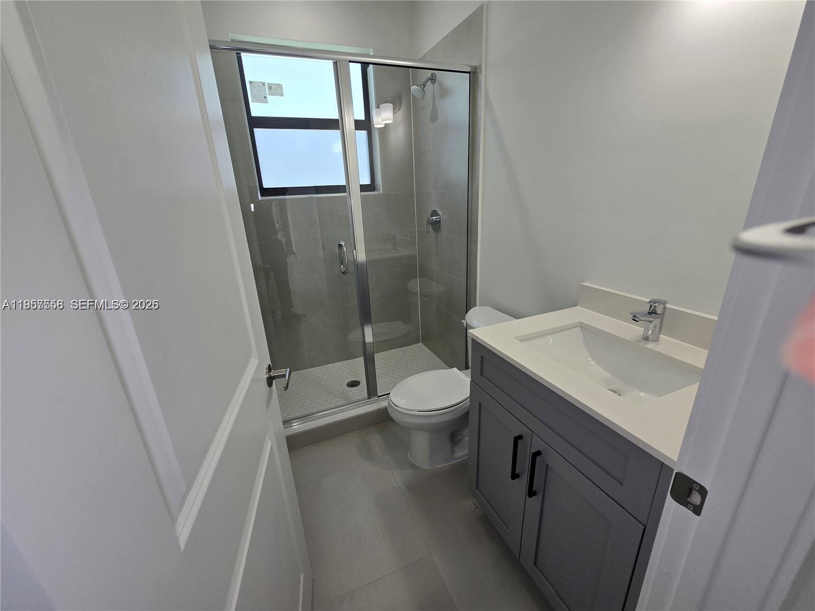 19534 Southwest 324th Street Homestead, FL 33030 - Photo 22 of 86 a bathroom with a sink a toilet and shower