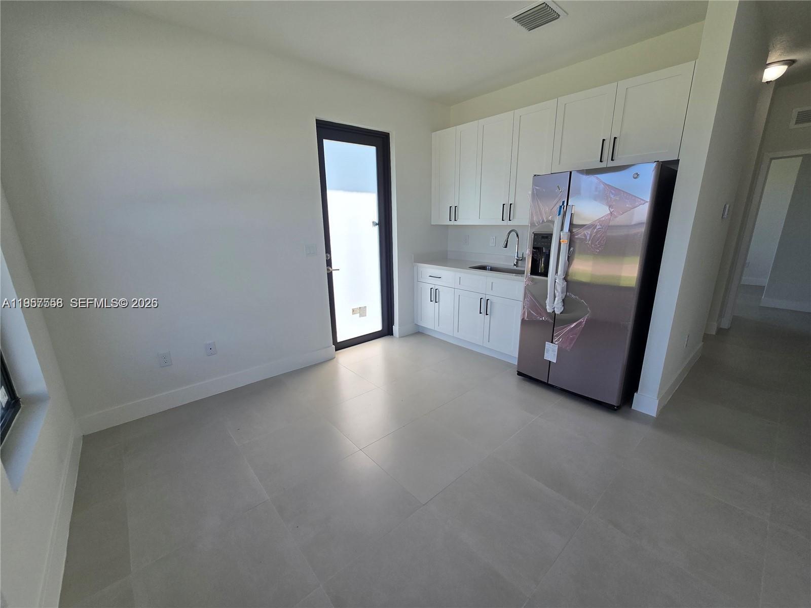 19534 Southwest 324th Street Homestead, FL 33030 - Photo 31 of 86 a view of a kitchen with refrigerator and cabinet