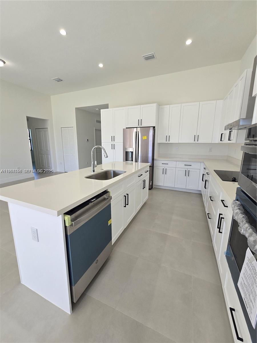 19534 Southwest 324th Street Homestead, FL 33030 - Photo 45 of 86 a kitchen with granite countertop a sink and cabinets