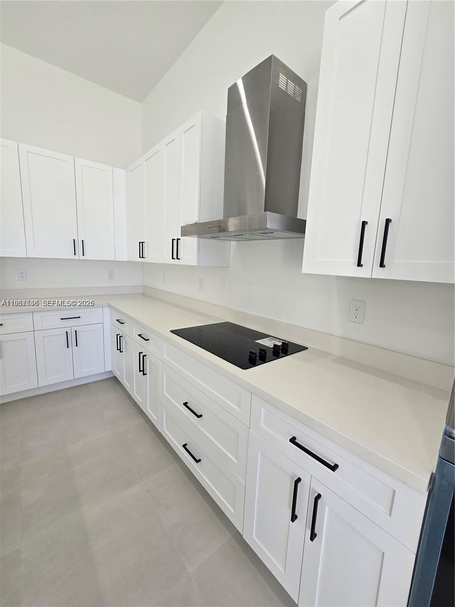 19534 Southwest 324th Street Homestead, FL 33030 - Photo 49 of 86 a kitchen with granite countertop white cabinets and white appliances