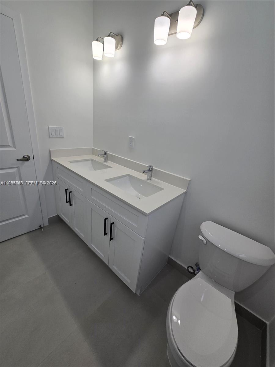 19534 Southwest 324th Street Homestead, FL 33030 - Photo 56 of 86 a bathroom with a toilet sink and mirror