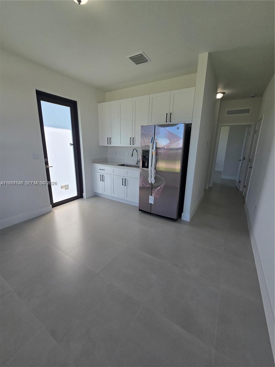 19534 Southwest 324th Street Homestead, FL 33030 - Photo 72 of 86 a view of a kitchen with furniture and wooden floor