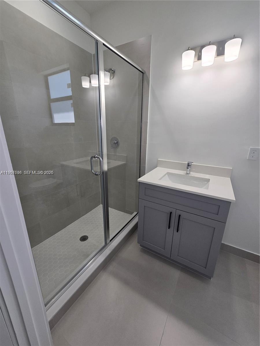 19534 Southwest 324th Street Homestead, FL 33030 - Photo 75 of 86 a bathroom with a sink a mirror and a shower