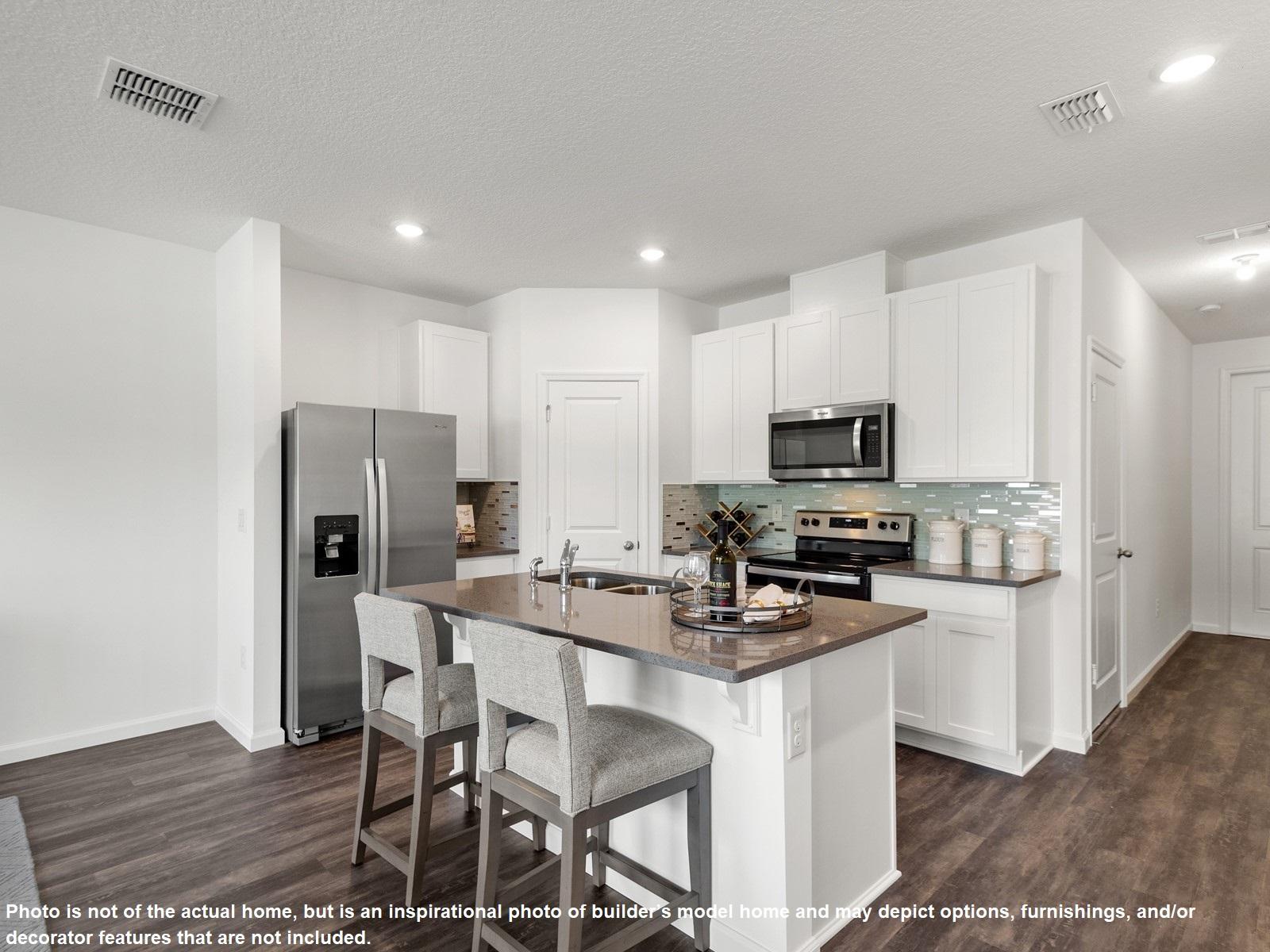 396 Southeast Sea Hunt Way Stuart, FL 34994 - Photo 4 of 10 a kitchen with stainless steel appliances a refrigerator stove microwave and cabinets