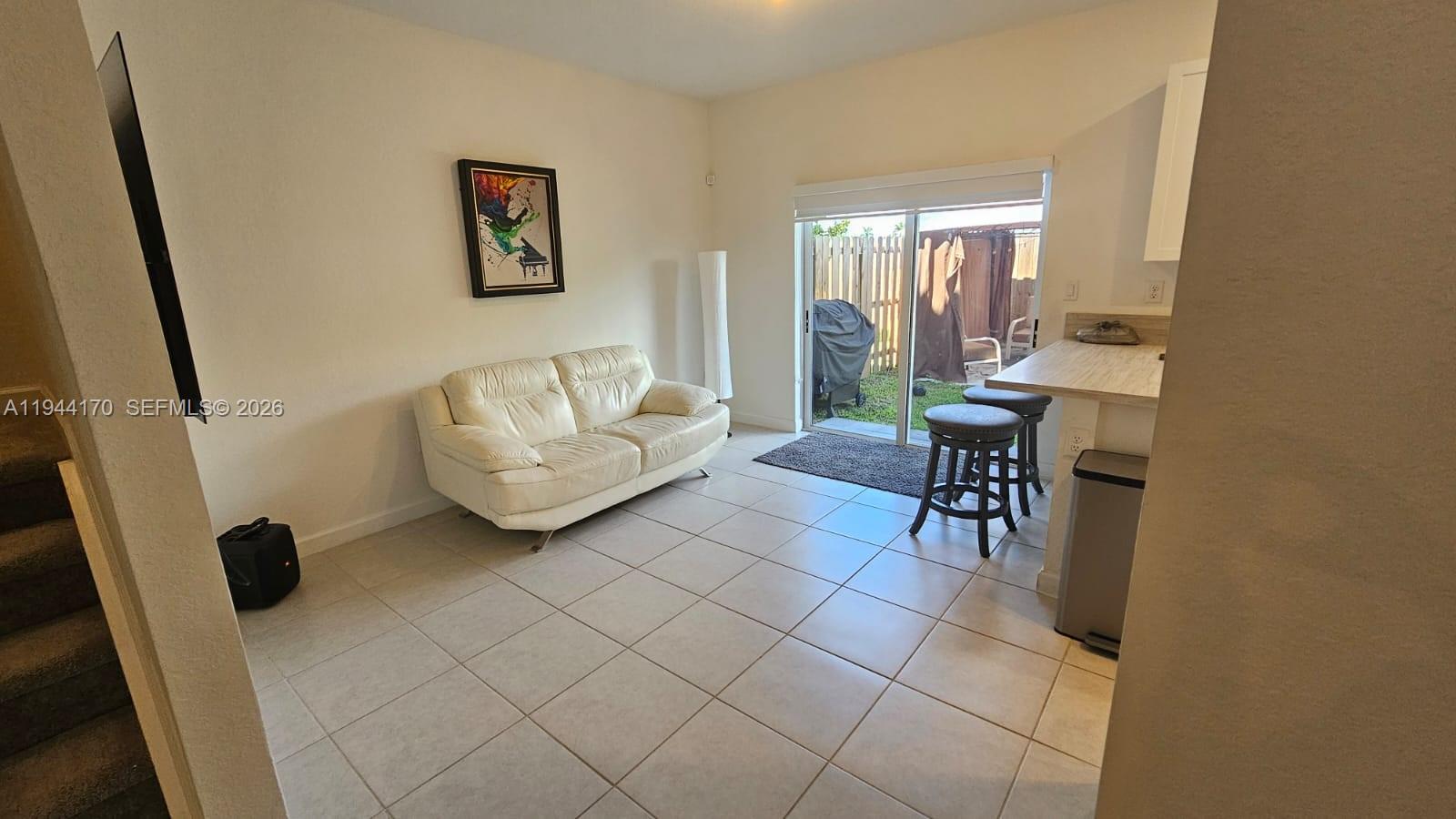 1146 Southeast 26th Street Homestead, FL 33035 - Photo 11 of 42 a living room with furniture and a window