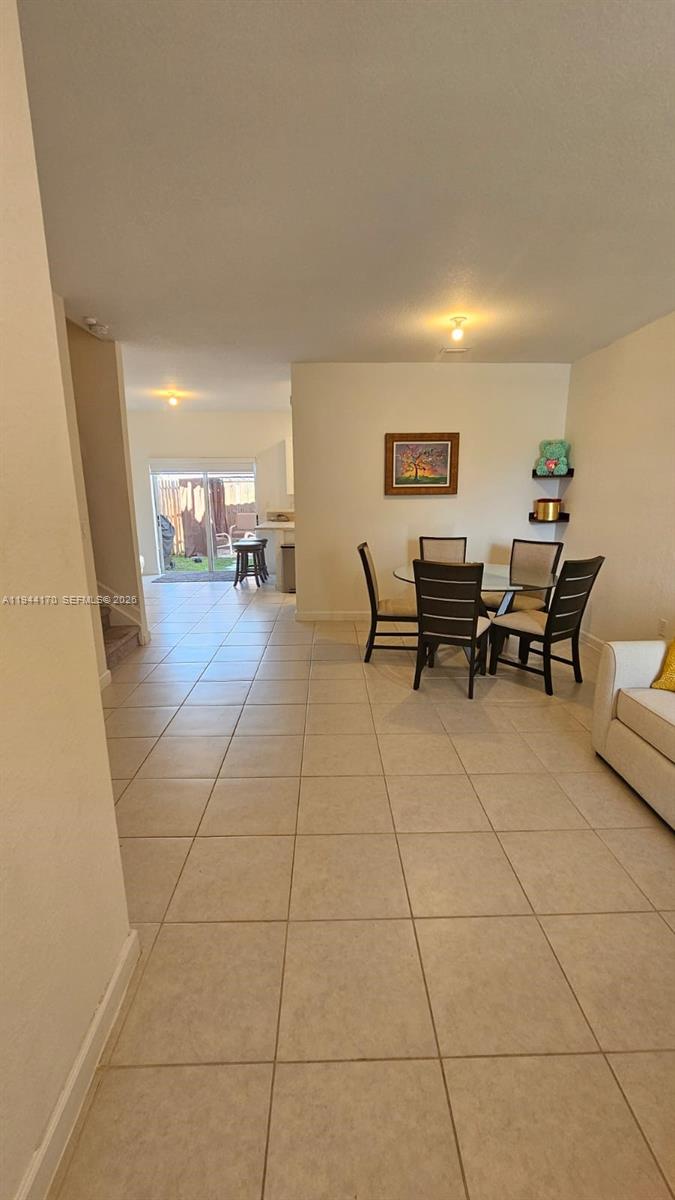1146 Southeast 26th Street Homestead, FL 33035 - Photo 13 of 42 a living room with furniture and a dining table