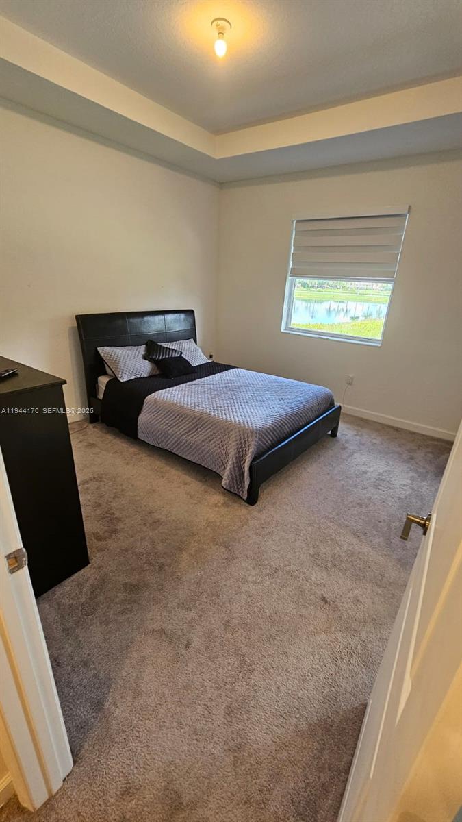 1146 Southeast 26th Street Homestead, FL 33035 - Photo 16 of 42 a bedroom with bed and window