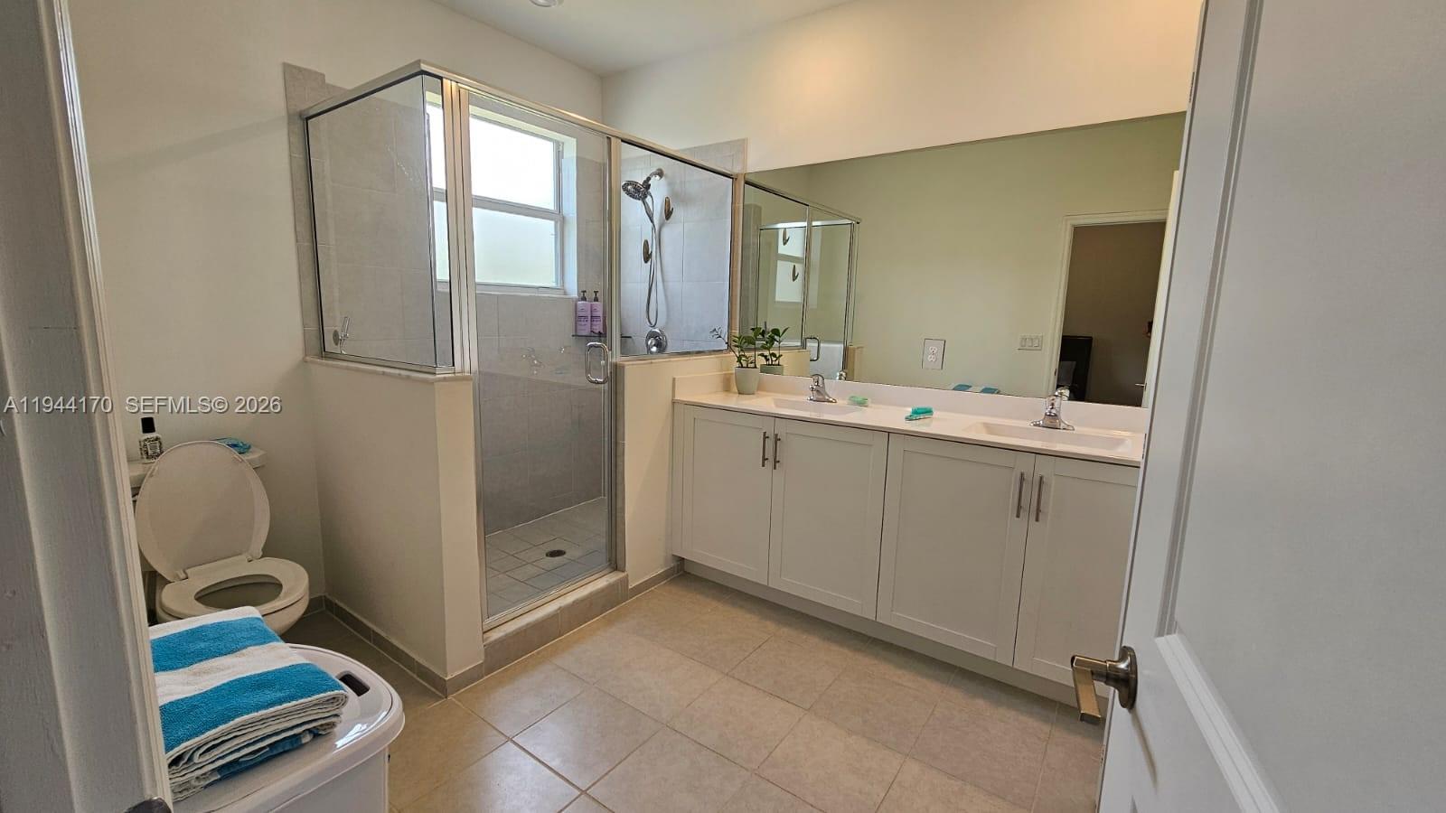 1146 Southeast 26th Street Homestead, FL 33035 - Photo 18 of 42 a bathroom with a double vanity sink and mirror