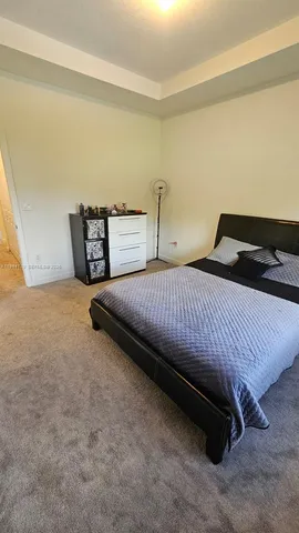 a bedroom with a bed and a cabinets