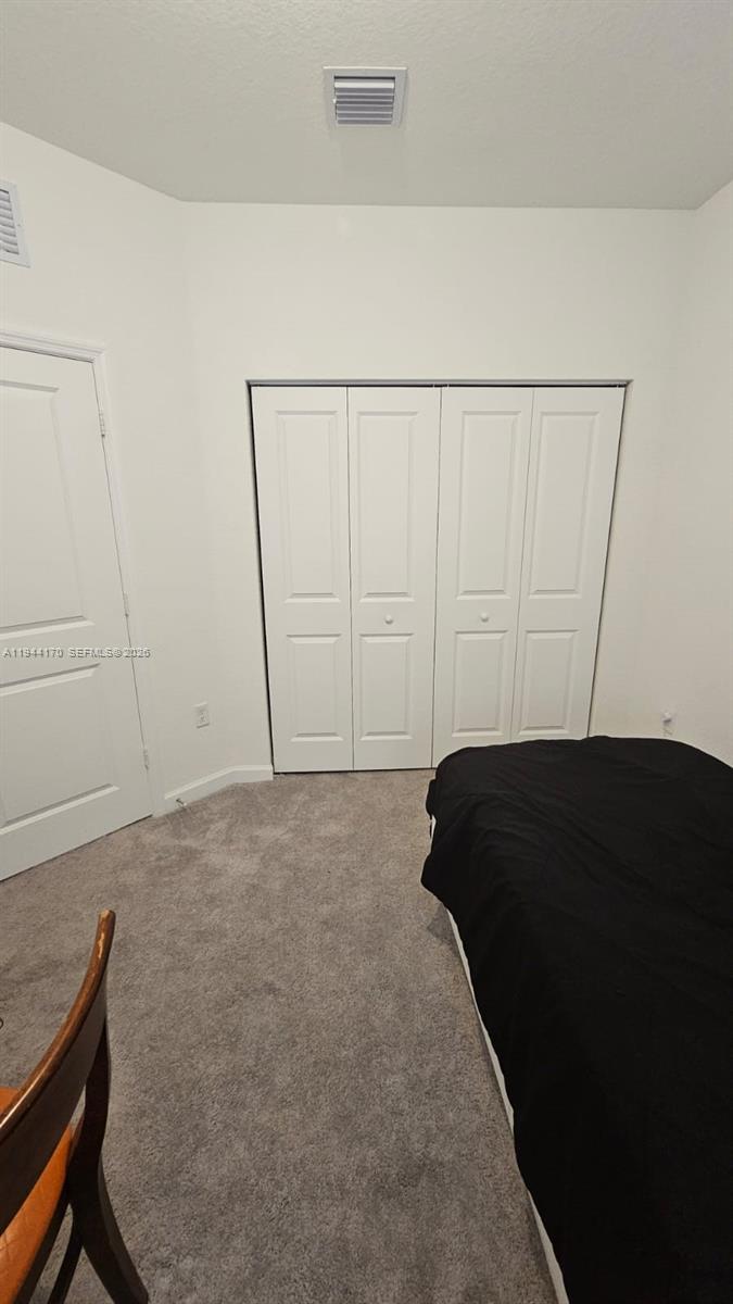 1146 Southeast 26th Street Homestead, FL 33035 - Photo 25 of 42 a view of room with a chair