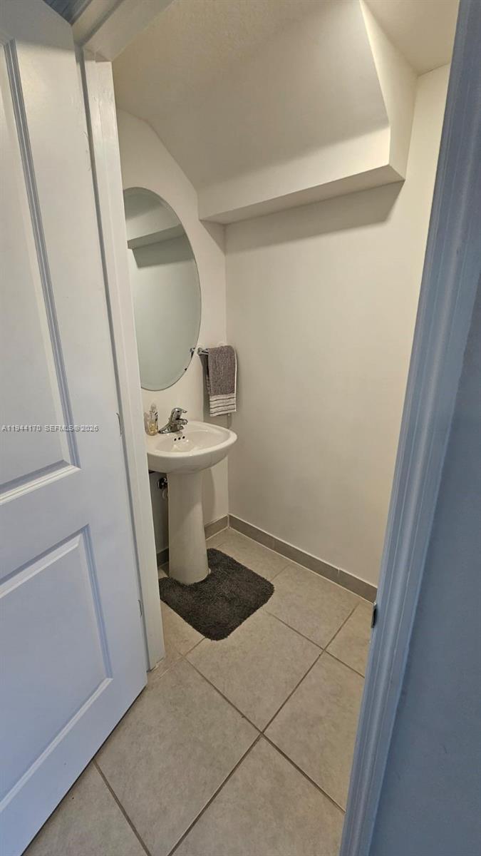 1146 Southeast 26th Street Homestead, FL 33035 - Photo 28 of 42 a bathroom with a sink a toilet a mirror and vanity