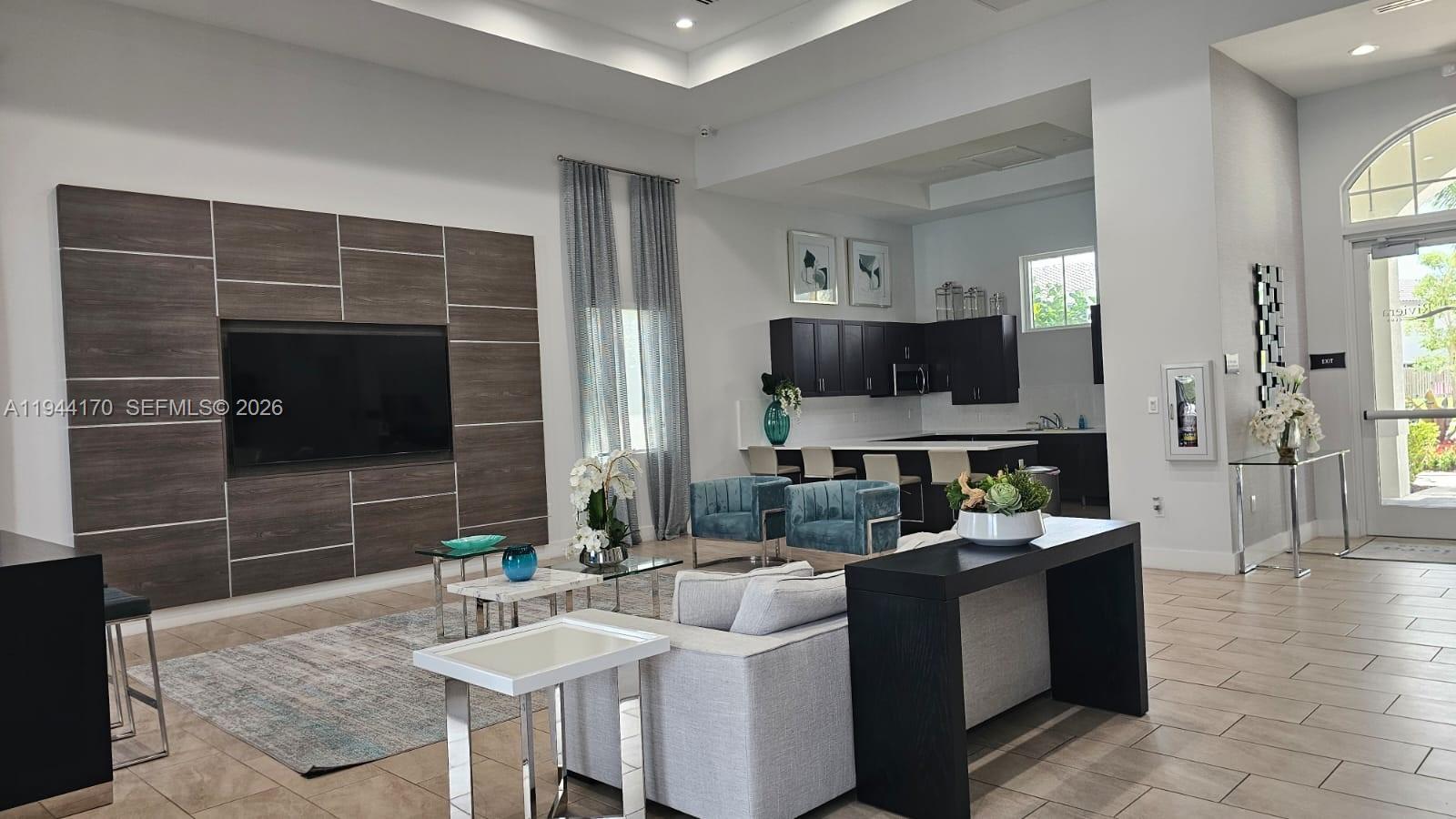 1146 Southeast 26th Street Homestead, FL 33035 - Photo 35 of 42 a living room with furniture a flat screen tv and a fireplace