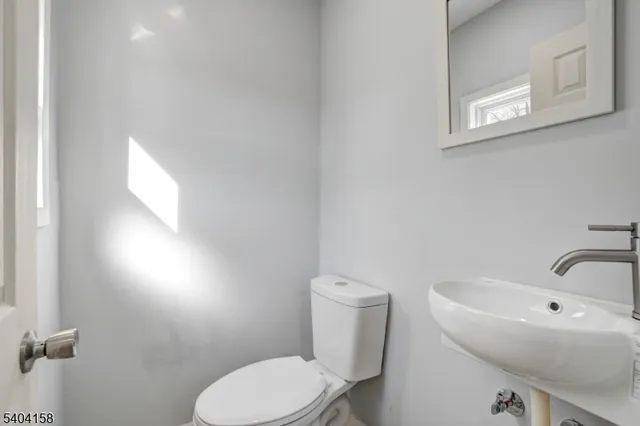 a white toilet sitting next to a white sink