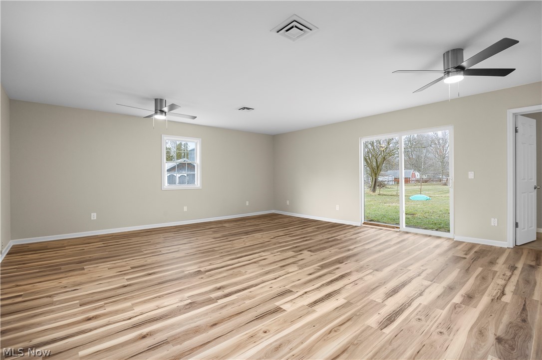 12452 Island Road Grafton, OH 44044 - Photo 10 of 39 Unfurnished room with a ceiling fan and light wood-type flooring