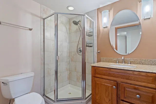 a bathroom with a shower a sink and a mirror