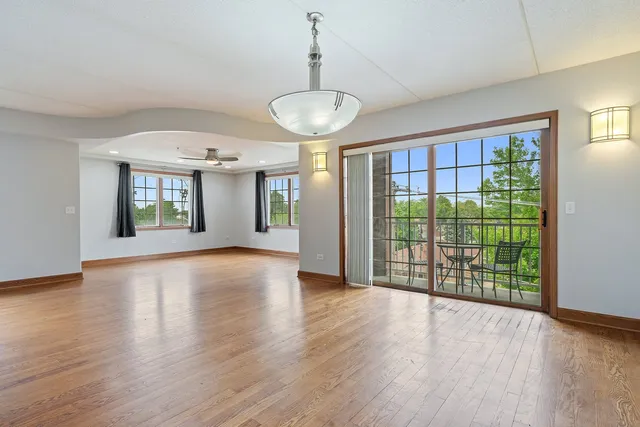 a view of an room with wooden floor and chandelier