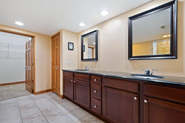 a bathroom with a double vanity sink and mirror