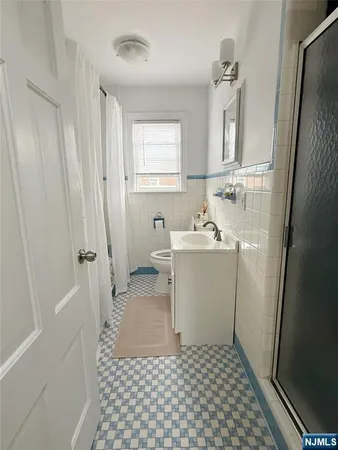 a bathroom with a sink a mirror and a shower