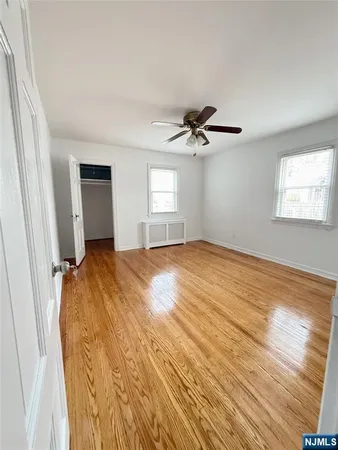 a view of a livingroom with a hardwood floor and a ceiling fan