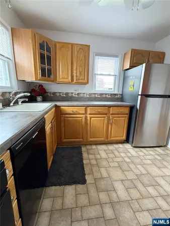 a kitchen with stainless steel appliances a sink stove and cabinets